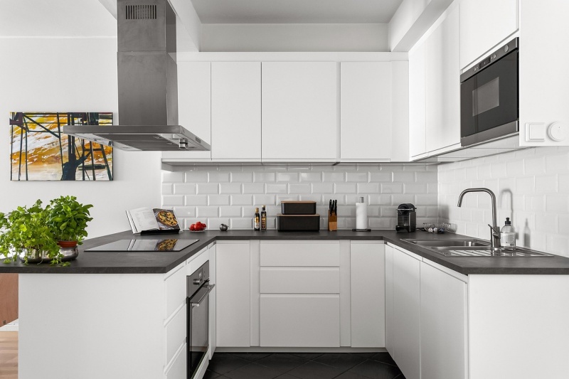 oak cabinets with black countertops
