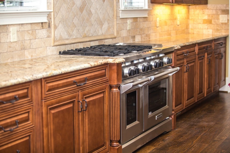 Rustic tan travertine with dark wood cabinets Rustic tan travertine with dark wood cabinets